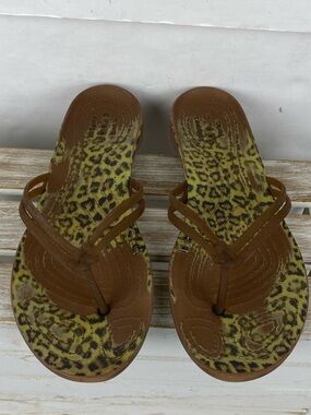 Crocs flip-flops brown strap and a yellow and brown animal print footbed size 9